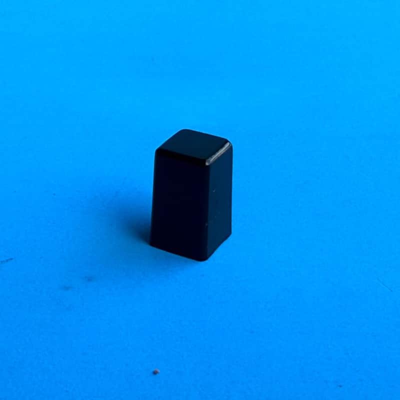 Metal electronic component with silver and brown casing on blue background.