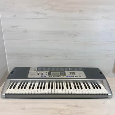 Casio LK-100 61-Key Lighted-Key Portable Keyboard w/ Books & CDs