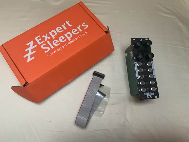 Black electronic keypad with white and orange lettering and buttons.