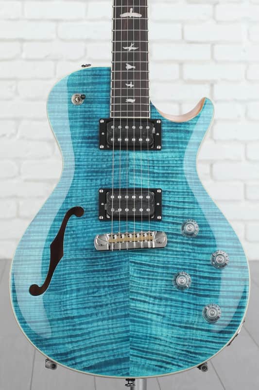 Bright blue electric guitar with wooden neck and chrome hardware.