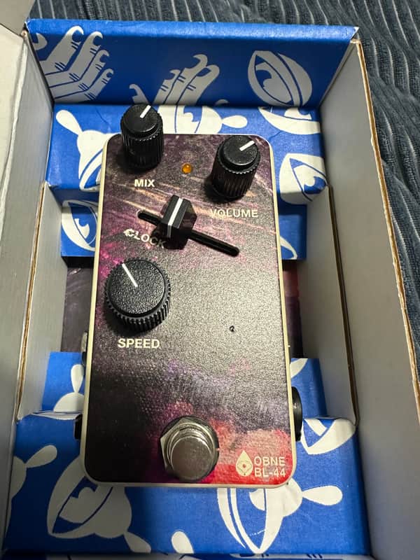 Purple guitar effects pedal with white knobs and footswitch.