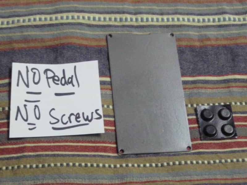 used Boss bottom plate (NO: rubber padding,label,serial number) for compact sized pedal - specifically from mid 1980s - metal, OUTER side: semi-gloss gray fiish / INNER side: flat gray finish -- back end has factory made small cut out for power jack image 1