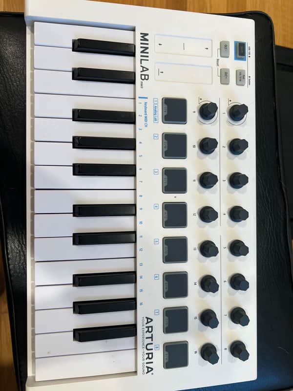 White MIDI keyboard controller with black keys and Arturia branding.