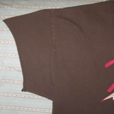 pre-owned genuine Fender Lightning Bolt Logo Short Sleeve, Cotton T-Shirt, XL, Brown (sleeves cut shorter) PN: 9101008621, from 2010, GRAPHIC: Red, Creme, Dark Brown, Fender, Ligntning Bolt, Circles, musical symbols, Electric Instrument Company Since 1946 image 10