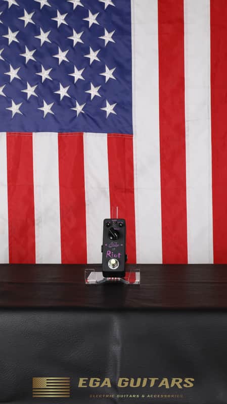 Black guitar effects pedal with knobs, switches, and "Subs Riot" text.