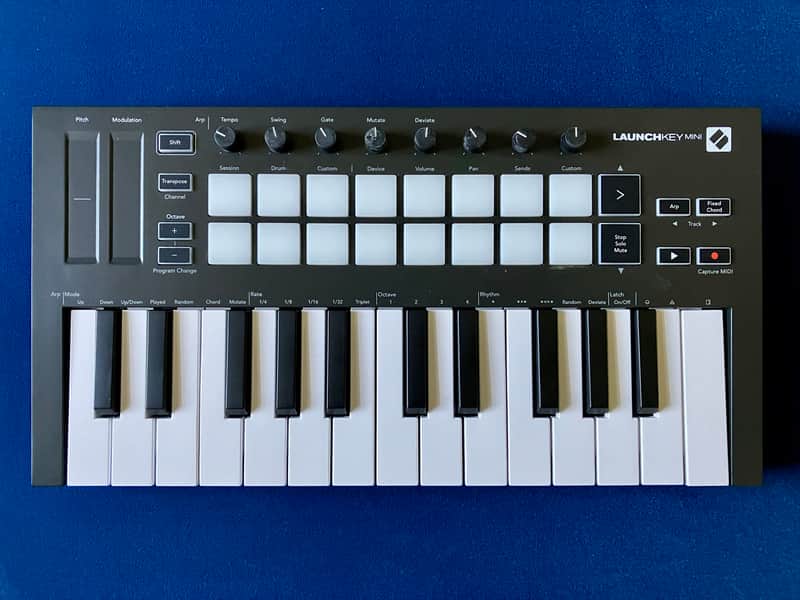 Black and white MIDI keyboard controller with included software box.