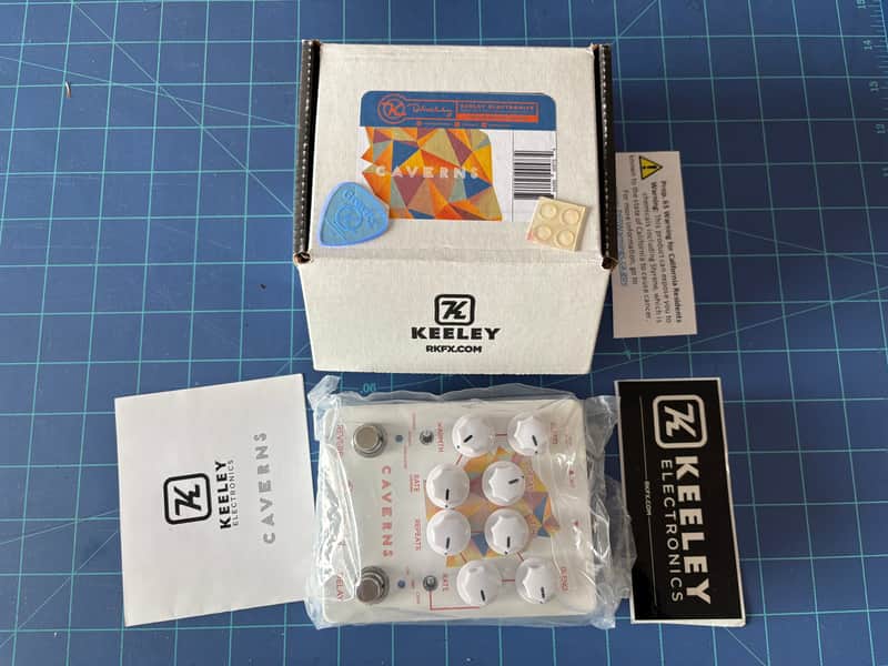 Cardboard box containing black items and a yellow/white insert.