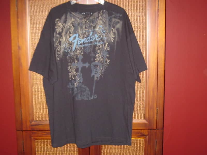 new old stock genuine Fender Heaven's Gate Custom Shop 100% Cotton Black Short Sleeve T-Shirt, XXL (XX-Large) (part #): 9101040806, early 2010s, GRAPHIC: Tan, Blue, Brown, Black (cross, 2 guitars, floral swirl, Fender, Custom Shop) NO: hang tag/packaging image 1