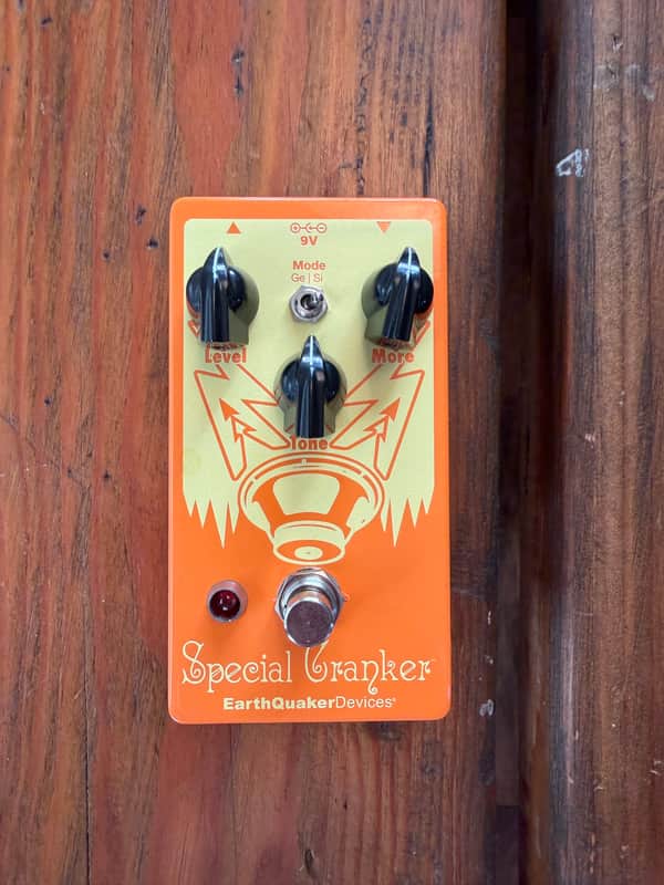 Red and white guitar effects pedal with knobs and footswitches.