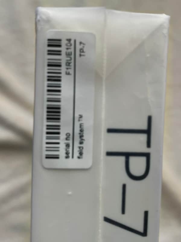 White, square, empty display case with "TP-7" printed on the front.