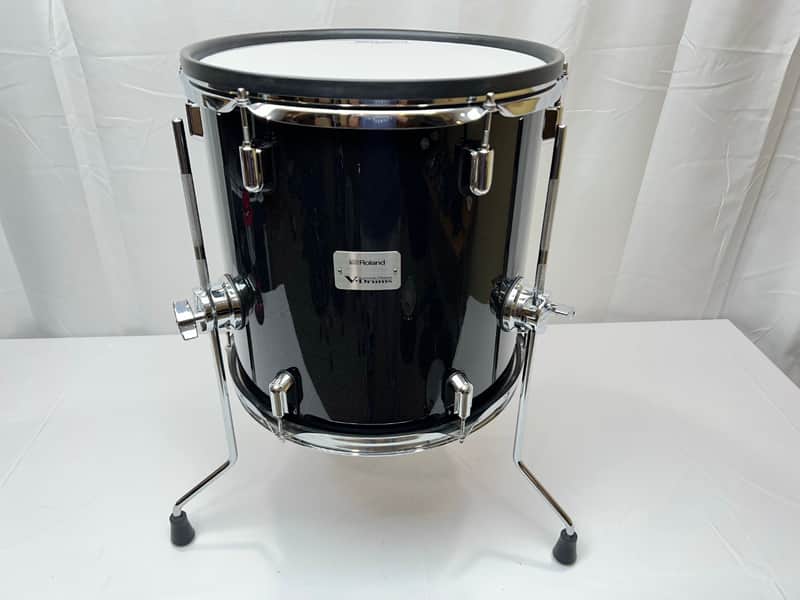 Black drum with chrome hardware on stands. Roland logo visible on shell.