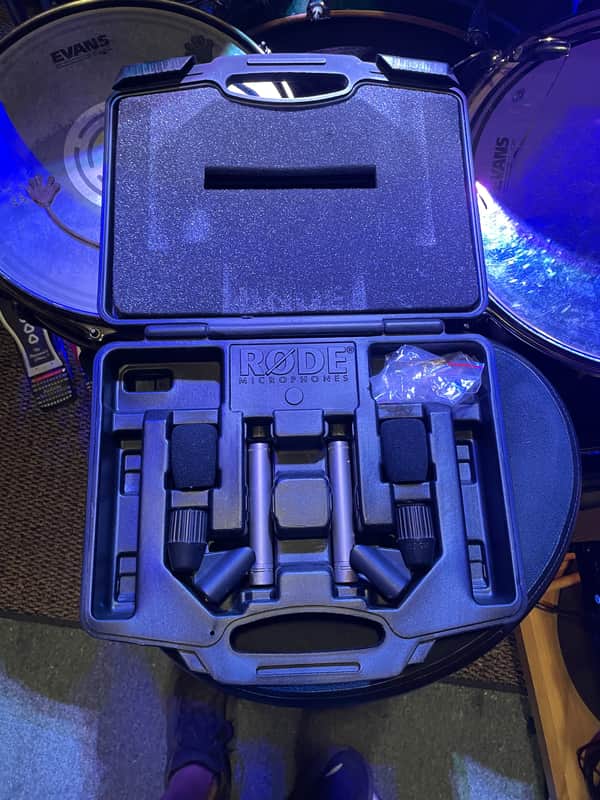 Black Rode microphone case open, showing microphone accessories inside.