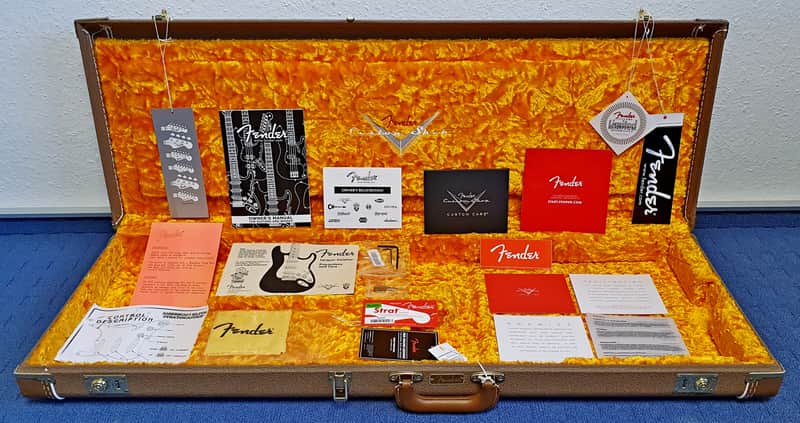 Red velvet presentation box containing small cards and papers.