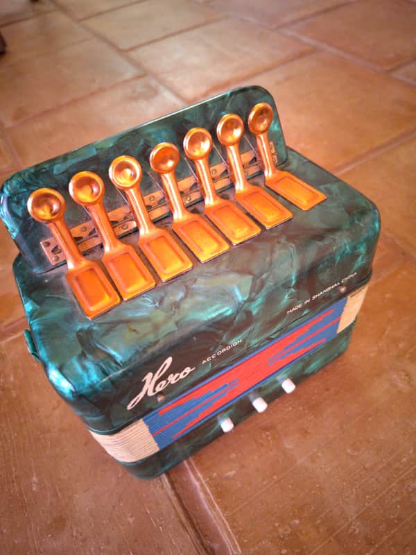 Hero Accordion 1950-1960 - Green pearl/marbled casing, fabric and patterned paper bellows, and copper/aluminum spoon-style keys. image 1
