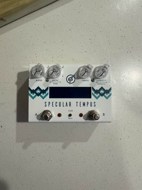 White and teal digital effects pedal with knobs and display screen.