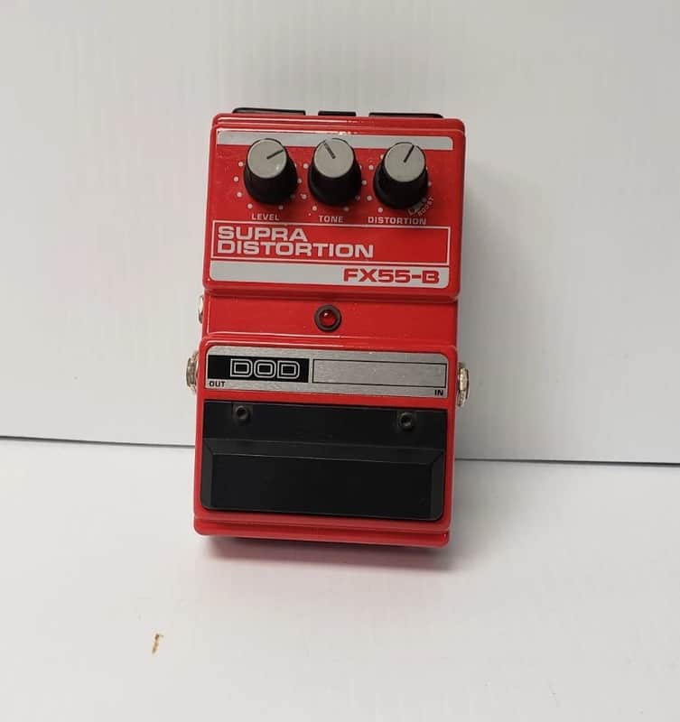 Red guitar effects pedal with knobs labeled Level, Tone, Distortion.