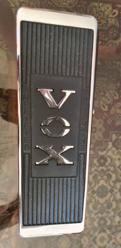 Silver and black guitar effects pedal with "VOX" logo on top.