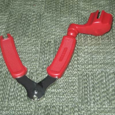 new old stock open package A+ D'Addario / Planet Waves 1st ver Pro-Winder RED String Winder & Cutter & Bridge PIn Puller, has different handle design than current DP0002 model,  from 2000s - for guitars, banjos, ukuleles, and mandolins image 12