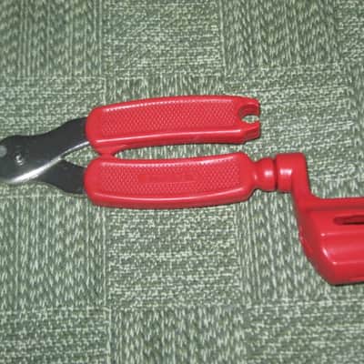 new old stock open package A+ D'Addario / Planet Waves 1st ver Pro-Winder RED String Winder & Cutter & Bridge PIn Puller, has different handle design than current DP0002 model,  from 2000s - for guitars, banjos, ukuleles, and mandolins image 7