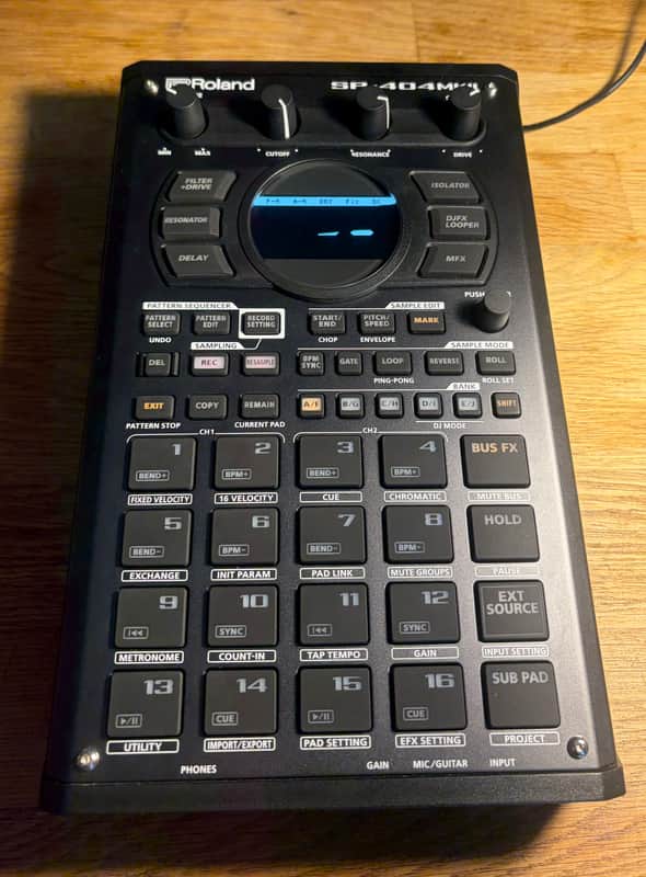 Roland SP-404MKII sampler, silver and black, electronic music production device.