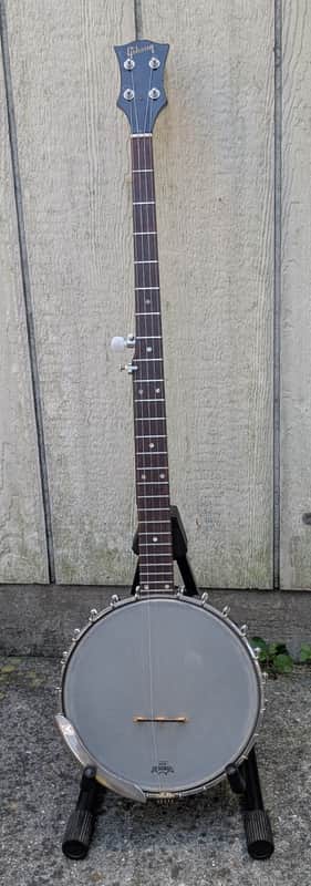 White banjo with chrome hardware and wooden neck.