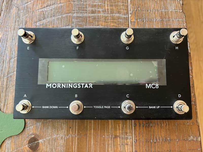 Black guitar effects pedal with green display, labeled "MORNINGSTAR MC8".