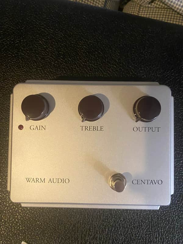 White and silver audio equipment in open box with black and white packaging.