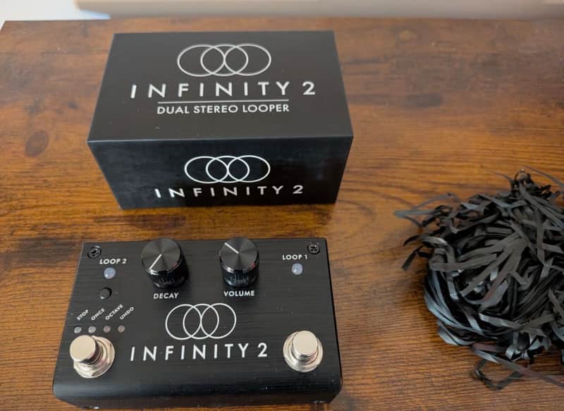 Black guitar effects pedal labeled "INFINITY 2" with knobs and switches.