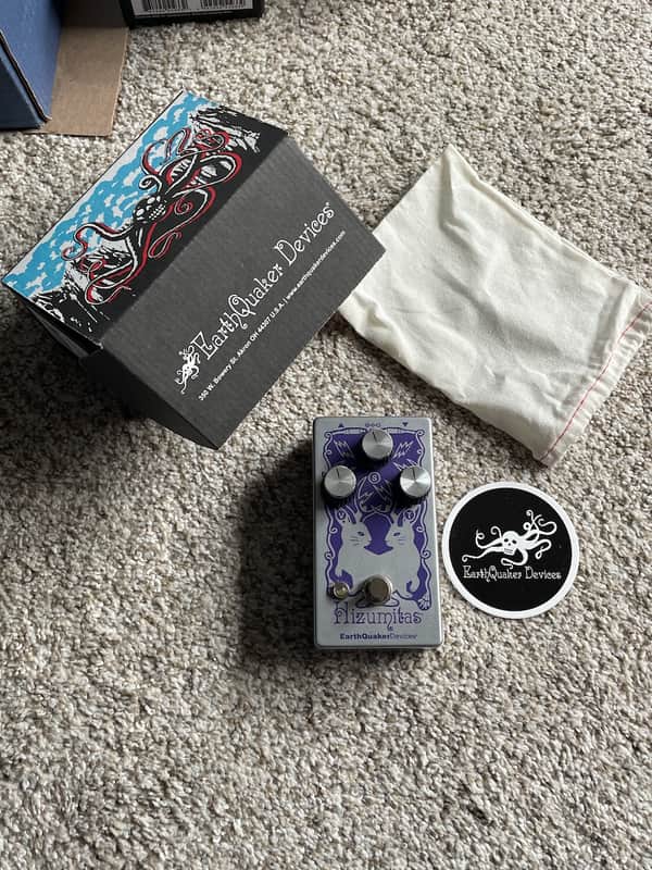 Silver guitar effects pedal with purple rabbit graphic and three knobs.