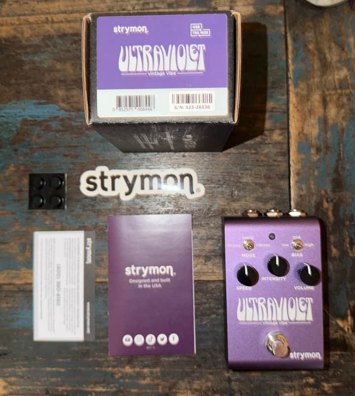 Purple stompbox guitar effects pedal with black knobs and silver accents.