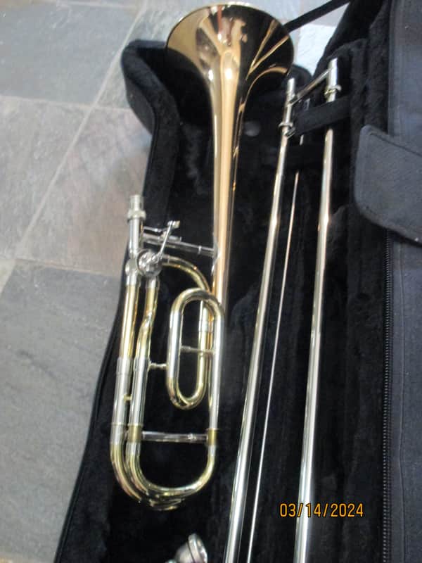 New Gold color trigger trombone. With case and mouthpiece. image 1