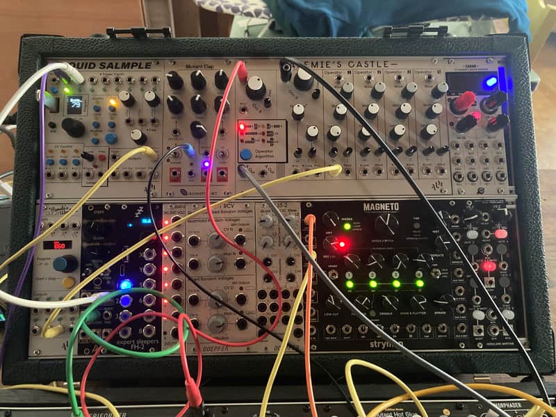 Small, silver/grey electronic module with knobs and jacks.