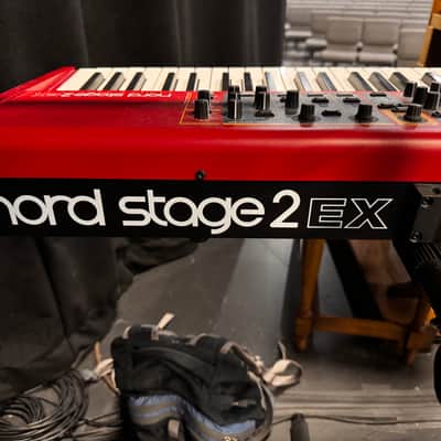 Nord Stage 2 Ex 88 2015-2017 - signature red painted chassis paired with distinct, exposed wooden side panels (cheeks) that give it a premium, classic-meets-modern aesthetic. image 8