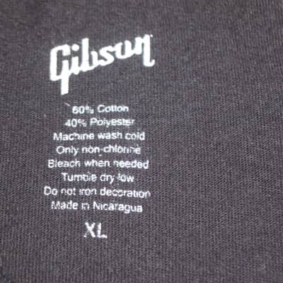 lightly worn genuine Gibson Firebird T-Shirt XL (X-Large), Black with Red Graphic, 60% Cotton / 40% Polyester - short sleeve GIBS-GA-FBBMXL (GA-FBBMXL) UPC # 711106533919, part of back neck area & right shoulder were re-stitched image 2