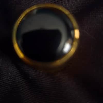 Gold and black tone knob with screw image 1