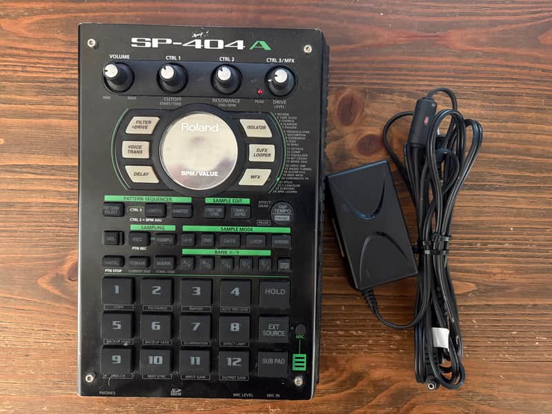 Black Roland SP-404A sampler with knobs, display, and various function buttons.