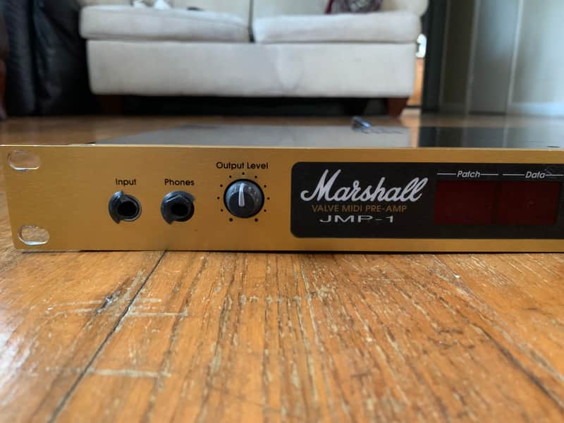 Marshall JMP-1 valve midi pre-amp, black and gold, on a wooden table.
