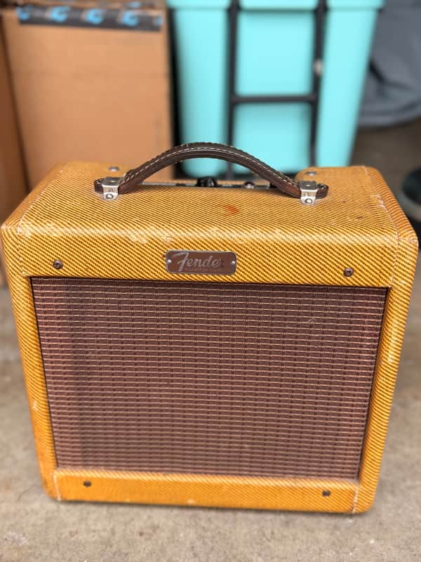 Vintage Fender tweed speaker cabinet, brown and tan, showing signs of age.