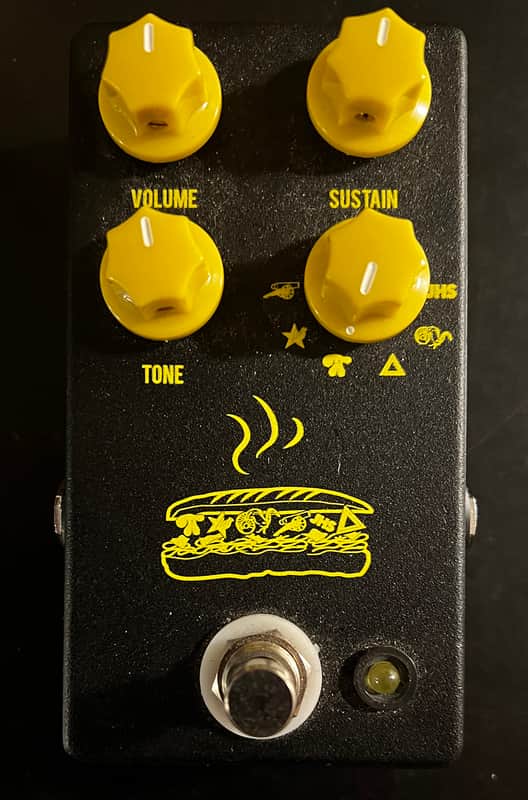 Black guitar effects pedal with four knobs and a footswitch.