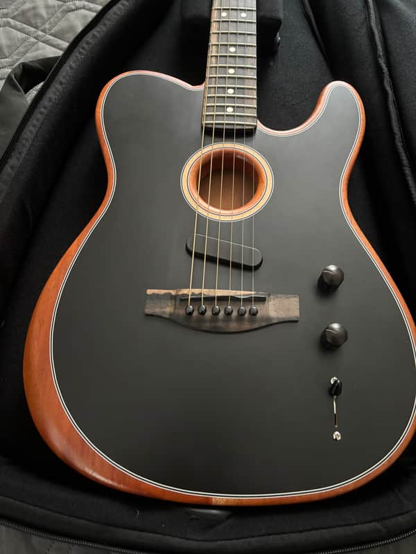 Red hollow-body electric guitar with chrome hardware, visible soundhole.