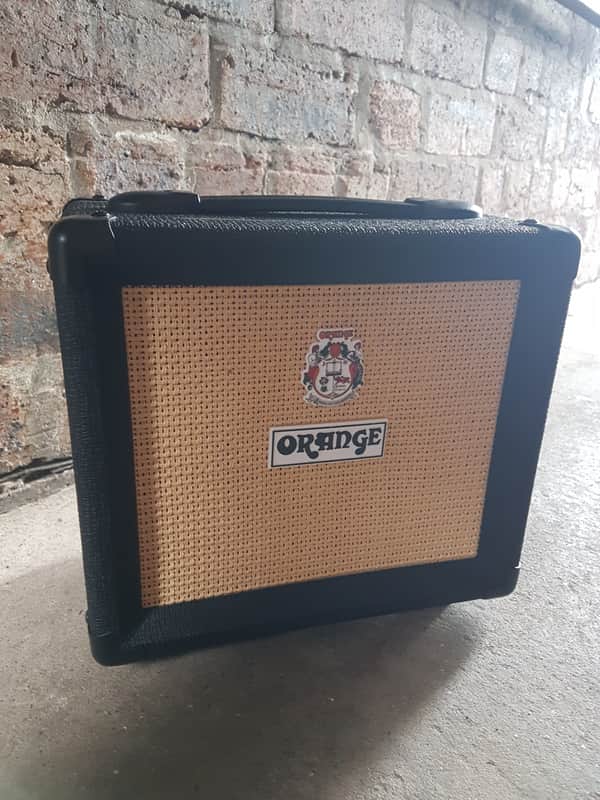 Orange amplifier head in orange and black case, visible logo.