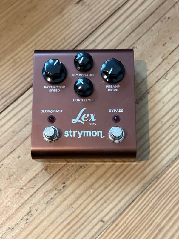 Orange stompbox pedal with black knobs and text labels.