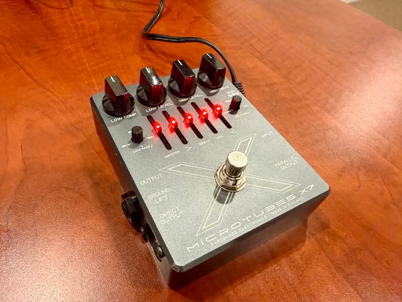Black guitar effects pedal with knobs and jacks, showing "Microtubes X7".