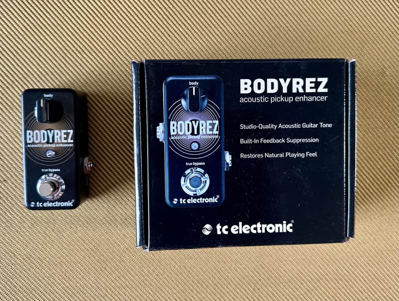 Black guitar effects pedal with gold concentric circle design and knobs.