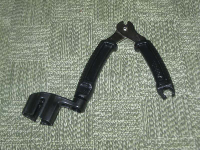 new (no package) very near A+ D'Addario Planet Waves PRO-WINDER Black String Winder & Cutter & Bridge Pin Puller DP0002 for guitar, mandolin, ukulele & banjos (black hard plastic with hardened steel wire cutters) just has few minor natural imperfections image 1