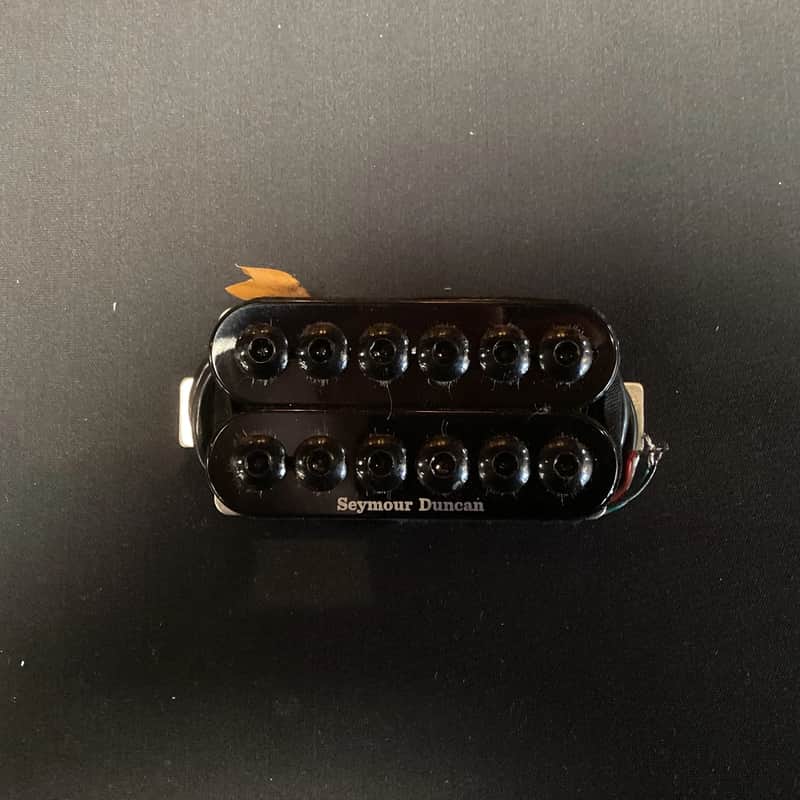 Two sets of black humbucker pickups in clear plastic case.