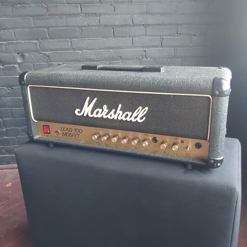 Black Marshall Lead 100 MOSFET amplifier head with gold control panel.