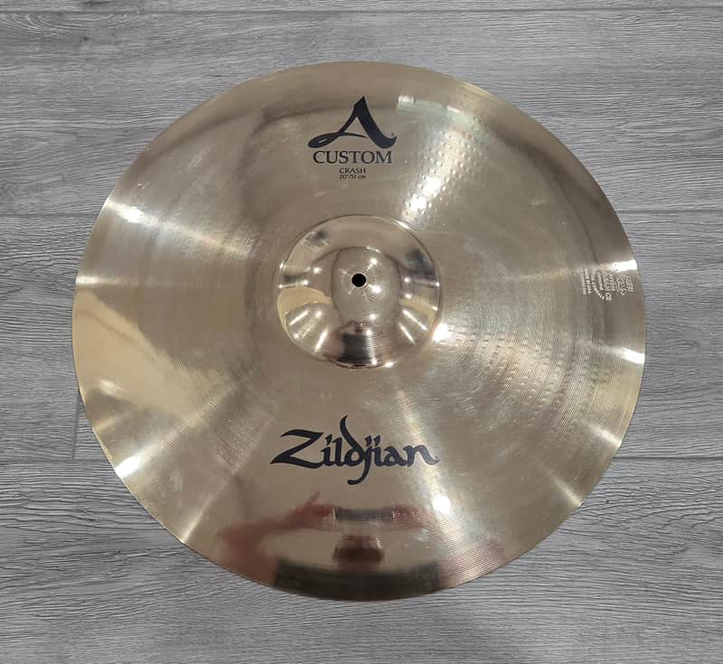 Silver cymbal with "CUSTOM" and "Zildjian" branding visible.