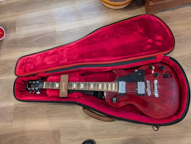 Black Gibson Les Paul electric guitar, solid black finish, visible hardware.