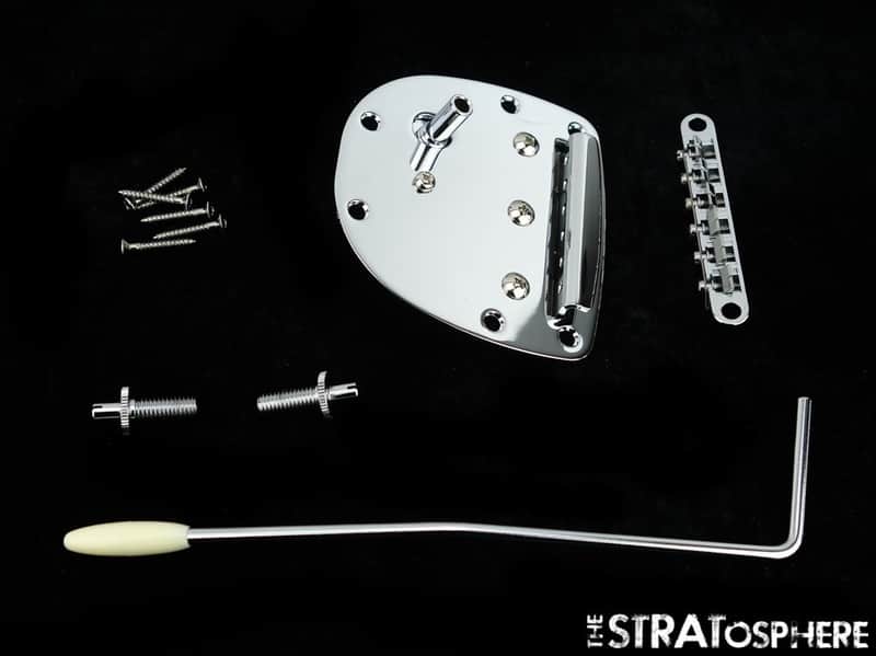 Silver metal parts, springs, and a black rod assembly laid out.